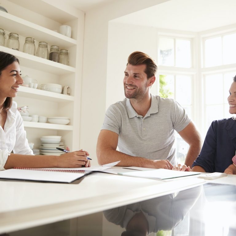 Family With Baby Meeting Financial Advisor At Home