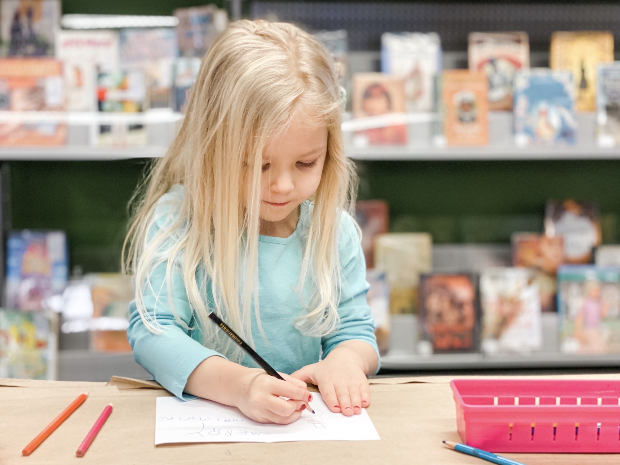 Preschool age girl writing a homemade card - crafts