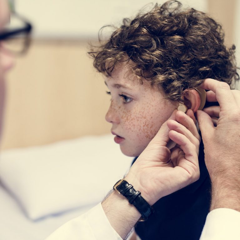Young boy having his ears checked