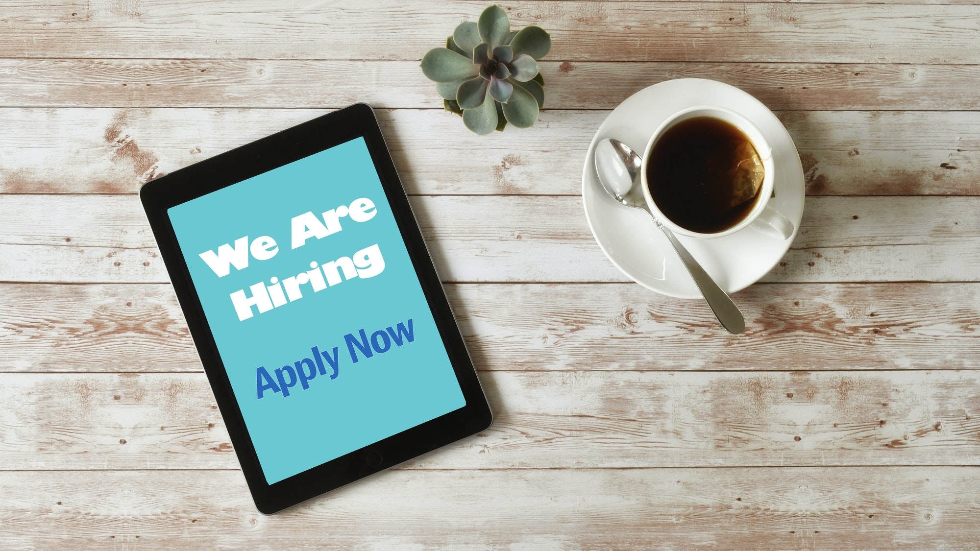 Online Job Search - We are Hiring Apply Now on tablet screen, minimal desk, overhead high angle iPad
