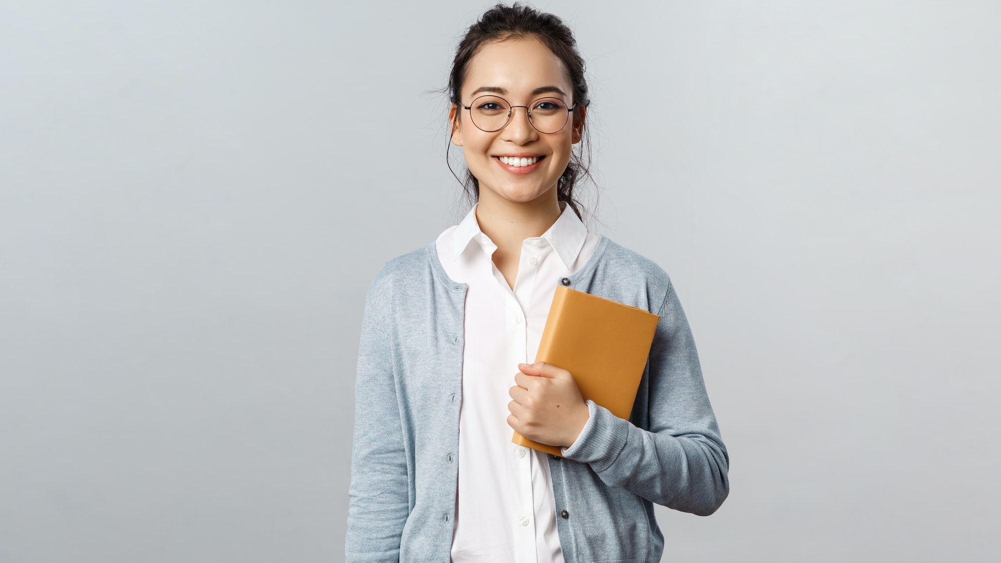 Education, teachers, university and schools concept. Young smiling woman, employer or student in