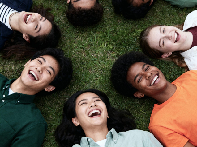 joyful-group-friends-laughing-grass